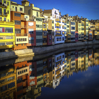 Buy canvas prints of Girona riverside apartments by Leighton Collins