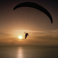 Buy canvas prints of paraglider over Gower by Leighton Collins