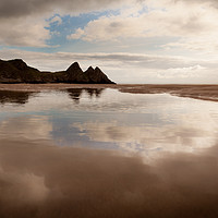 Buy canvas prints of Reflections of Three Cliffs Bay by Leighton Collins