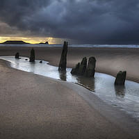 Buy canvas prints of Dramatic sunset at Worms Head and Rhossili Bay by Leighton Collins