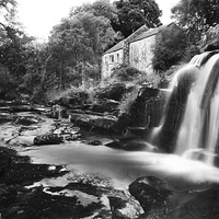 Buy canvas prints of Serene Mill House by the Falls by Les McLuckie