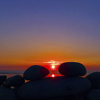 Buy canvas prints of Sunset Through The Pebbles by Pete Moyes