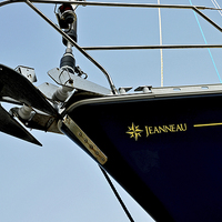 Buy canvas prints of A yachts bow against a blue sky by Frank Irwin