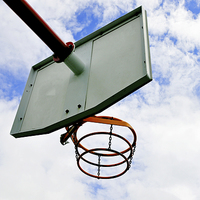 Buy canvas prints of A basketball hoop against a blue sky by Frank Irwin