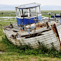Buy canvas prints of An abandoned and worse for wear boat by Frank Irwin