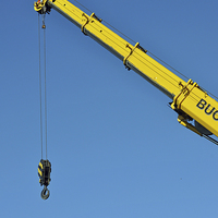 Buy canvas prints of A bright yellow crane jib set against a clear blue by Frank Irwin