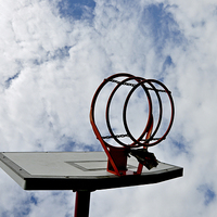 Buy canvas prints of A basketball hoop against a blue sky by Frank Irwin