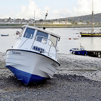 Buy canvas prints of A Leisure craft beached in Conway by Frank Irwin