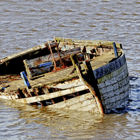 Buy canvas prints of An old rotting boat drifting aimlessly by Frank Irwin
