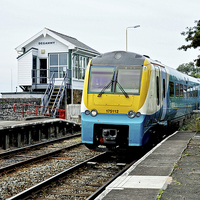 Buy canvas prints of An Arriva train arriving at Deganwy Station by Frank Irwin