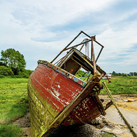 Buy canvas prints of An abandoned and worse for wear boat by Frank Irwin