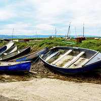 Buy canvas prints of A row of small boats beached awaiting the incoming by Frank Irwin