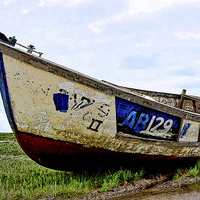 Buy canvas prints of  A Colourful boat lies on Heswall Beach by Frank Irwin