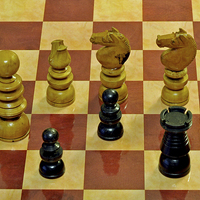 Buy canvas prints of  A Few old style Chess Pieces on a chess board by Frank Irwin