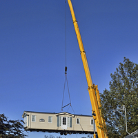 Buy canvas prints of A caravan on the end of a crane hook by Frank Irwin