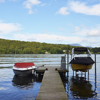 Buy canvas prints of Two boats tied to the mooring posts on a pier by Frank Irwin