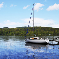 Buy canvas prints of A yacht lies anchored on Windermere by Frank Irwin