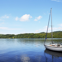 Buy canvas prints of A yacht lies anchored on Windermere by Frank Irwin