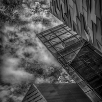 Buy canvas prints of Storm clouds over modern building by Gareth Burge Photography