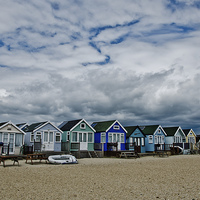 Buy canvas prints of Stormy skys over beach huts by Dan Ward