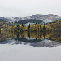 Buy canvas prints of Loch Ard autumn reflections by Dan Ward