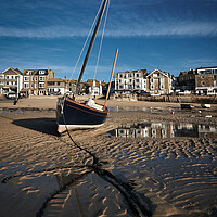 Buy canvas prints of Fishing boat catching the early morning light in St Ives harbour, Cornwall by Dan Ward