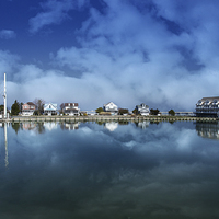 Buy canvas prints of  Houses Reflecting In The Bay by Tom and Dawn Gari