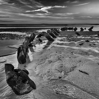 Buy canvas prints of Old wreck on Bamburgh beach by David Preston