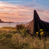 Buy canvas prints of Boat hut and Lindisfarne Castle at sunrise by David Preston