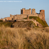 Buy canvas prints of Bamburgh castle at sunset by David Preston