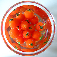 Buy canvas prints of A bowl of baby tomatoes arranged in water. by Elizabeth Debenham