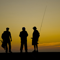 Buy canvas prints of Three fishermen at sunset by Andrew chittock