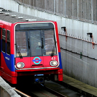 Buy canvas prints of The DLR at City Airport by Robert Cane