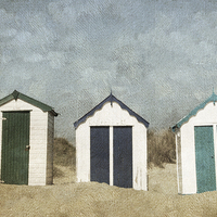 Buy canvas prints of Three Little Beach Huts Sitting on a Beach by Lesley Mohamad