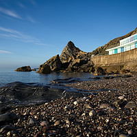 Buy canvas prints of Meadfoot Beach Huts And Imposing Cliffs by rawshutterbug 
