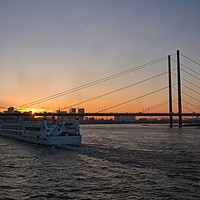 Buy canvas prints of Vessel Moving Along The Rhine Embankment  At Sunse by rawshutterbug 