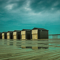 Buy canvas prints of beach huts at hastings pier  by Brett watson