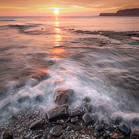 Buy canvas prints of Pebbles on Kimmeridge bay at Sunset by Kevin Browne