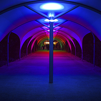 Buy canvas prints of Tunnel to North Greenwich Pier - Blue Lights by John Ly