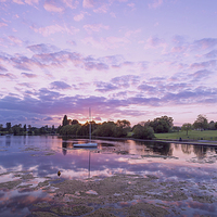 Buy canvas prints of  Purple Sunset Sky at Danson Park by John Ly