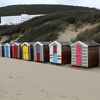 Buy canvas prints of  Bright beach huts at Saunton by Helen Cooke