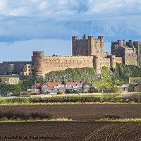 Buy canvas prints of Bamburgh Castle and St Aidans Church by Keith Douglas