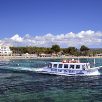 Buy canvas prints of  Glass Bottom Boat Heading out of Es Cana bay, Ibi by Mick Surphlis