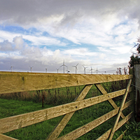 Buy canvas prints of Somerton Church Gate Looking at Windturbines by James Taylor