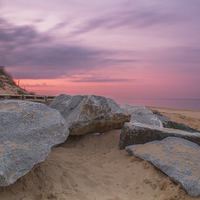Buy canvas prints of  Sunset by the Rocks at Hemsby Beach by James Taylor