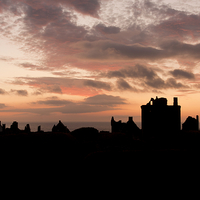Buy canvas prints of Sunrise at Dunnottar Castle by Tommy Dickson