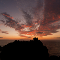 Buy canvas prints of Epic sky over Dunnottar Castle by Tommy Dickson