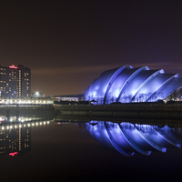 Buy canvas prints of Illuminated Armadillo on Glasgows Riverside by Tommy Dickson