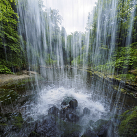 Buy canvas prints of  Under the waterfall. by Tommy Dickson