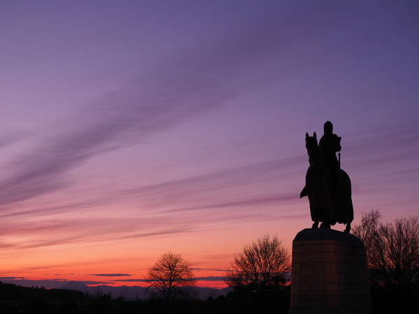 Robert the Bruce statue at sunset. Picture Board by Tommy Dickson